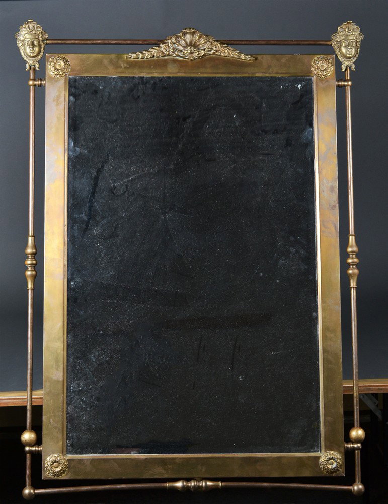A Very Fine Bronze Mirror in the Neoclassical Tast: With finely cast masks to top corners, centered by a bronze wreath and clam, the four corners with bronze rosettes, with beveled glass, with additional openwork frame in bronze tubing with bold turnin