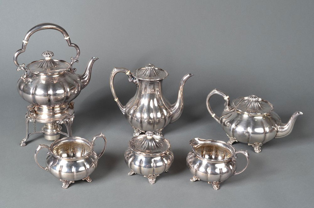 A Fine Six Piece Sheffield Silver Plate Tea Set: Of melon form, to include coffee pot, tea pot, hot water kettle, creamer, sugar and waste bowl. Stamped Made in Sheffield England with additional hallmarks. Largest pieces measures 13.25" H, circa ear