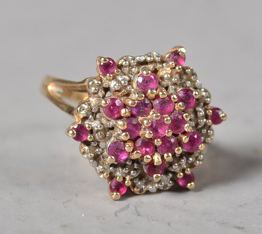 A 14K Gold, Ruby And Diamond Ring: Prong set ruby and diamond cluster ring in form of flower. Stamped 14K EV, size 6, 4 grams total weight. Private collection Gregory, Michigan
