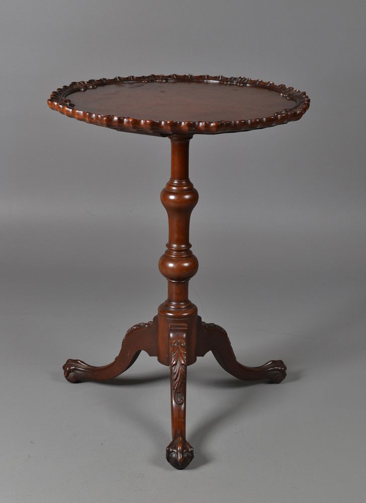 A Mahogany Pie Crust Tea Table: A fine mahogany with carved knees, ball and claw feet, boldly turned shaft, with pie crust top. Either American or Continental. 28" H x 21.75" W. Circa 1900. Private collection Troy, MI.