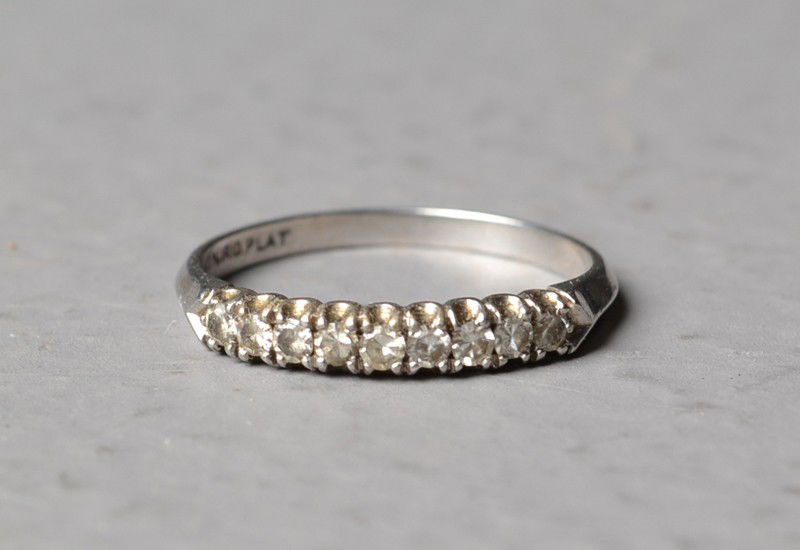 A Diamond And Platinum Wedding Band: A platinum band prong set with 9 small diamonds, stamped platinum, size 6, 3 grams total weight. Private collection Gregory, Michigan