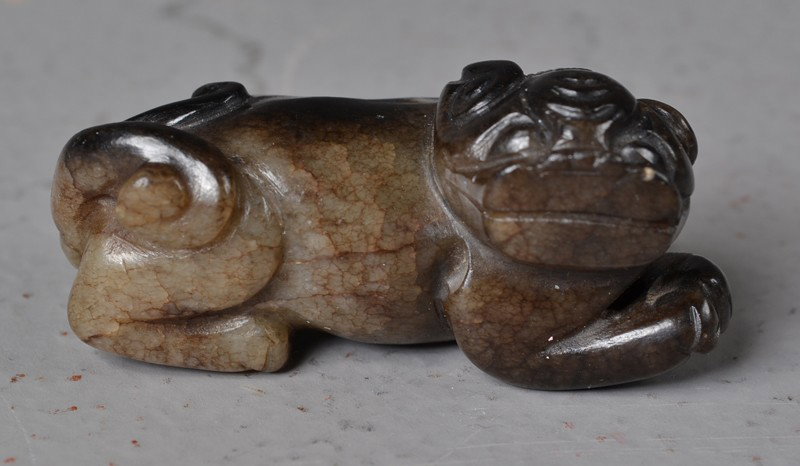 Chinese Late Ming Carved Jade Lion: Lion carved of dark brown/white jade, circa 16th-17th C., 2.3/8"L X 1"H X 1"D.