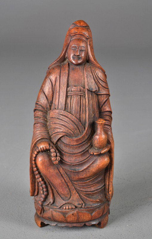 Chinese Qing Carved Bamboo Figure: Finely carved to depict a seating Guanyin 10"H, Circa 19th century.