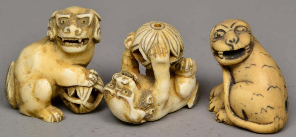 (3)Japanese Carved Ivory Netsuke: Probably Meji peroid, finely carved to depict foo dogs at play, two with balls that have smaller ivory balls within, with inked and dyed elements, two with character marks, tallest is 1.75" H. Private