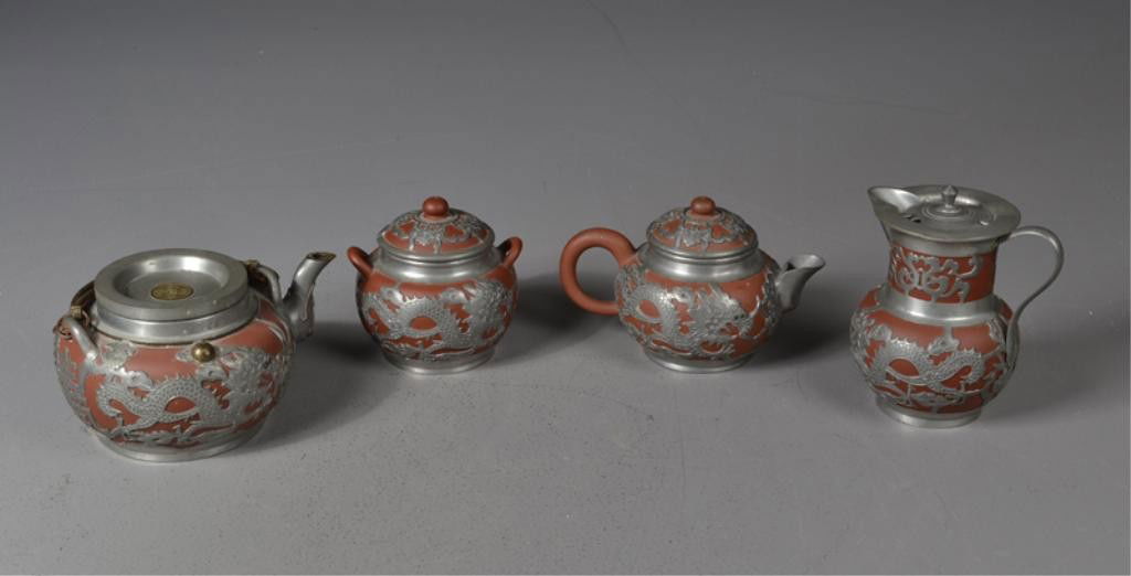 (4) Pc. Chinese Qing Pewter and Yixing Tea Set: A four piece tea set in Yixing pottery encased in pewter mounts finely carved to depict bats, dragons, and lotus each piece signed with oval seal mark and Chinese characters and further marked Hong Ko