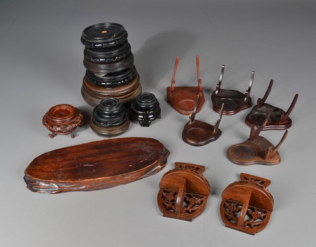 (20) Chinese Carved Wooden Stands: Including vase and bowls stands, plate stands, and hanging wall stands, circa late 19th early 20th century.