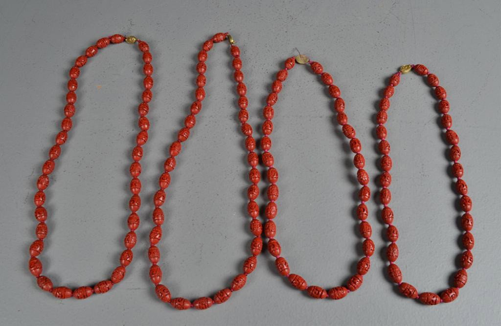 (4)Chinese Qing Cinnabar Necklaces: Carved to depict ruyi clouds and floral design, with gilt gold clasps, longest is 28.5" L, circa 20th century. Private collection Oxford MI.