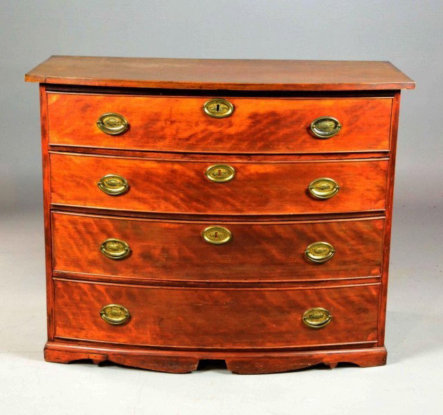 A Massachusetts Federal Chest Of Four Drawers: Cherry wood chest with overhanging molded top above a bank of four drawers, original brasses and center key escutcheons raised on bracket feet. 34" H x 42.5" W x 21.5" D, circa 1800. Condition the fee