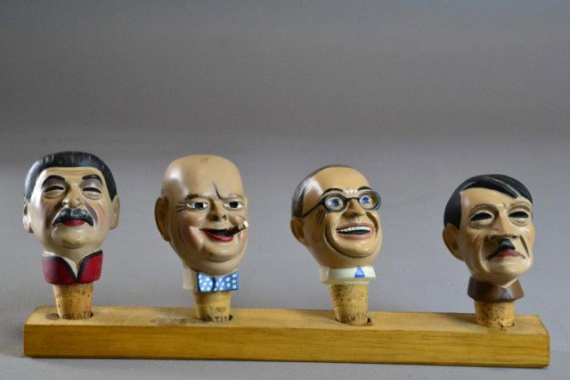 (4) WW2 LEADERS CORKSTOPPERS: Finely molded and hand painted porcelain corkstoppers, depicting four World War Two leaders: Truman, Churchill, Stalin, and Hitler, with wooden display stand, made in Germany, 4" H including cork, cir