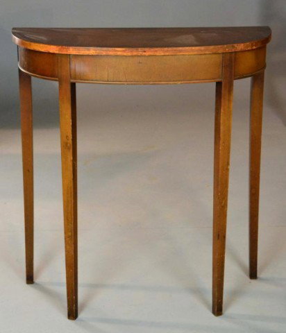 A Demi-Lune Mahogany Hall Table: Half circle top with smooth apron raised on tapered legs. 30.25" H x 28" W x 12" D. Made by Earle Rogers Fine Furniture Co. Surface wear to top and top outer edge area, circa 1940. Private collection 