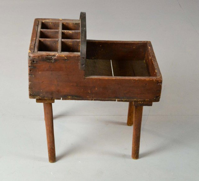 A Primitive Wood And Iron Blacksmith Tool Chest: Wrought iron handle with six wooden compartments for nails above one large compartment for tools and raised on tapered legs. 17.5" H x 13.75" W x 20.75" D