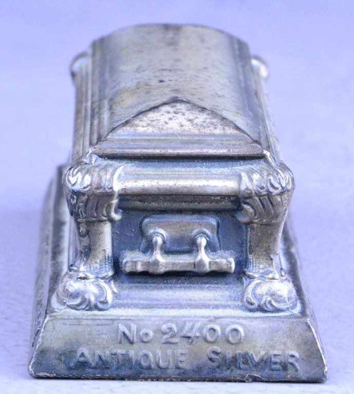 Metal Casket Form Paperweight Possible Salesmans Sample: Advertisement sampler for bronze caskets by the "Boyertown" famous bronze, with raised no 2200 bronze on one end and no 2400 antique silver on the reverse. Finely molded to depict a casket with ornate