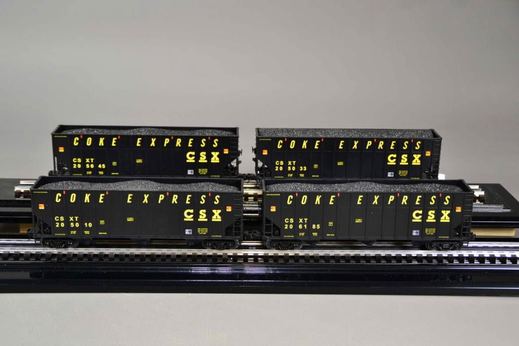 (4) M.T.H. ELECTRIC TRAINS - O SCALE: Including four CSX Coke Hopper Car Set w/ Coal Load, Item # 20-90517, painted black with yellow logo and lettering. 14" L each, die cast, new in box. Private collection Metamora MI.