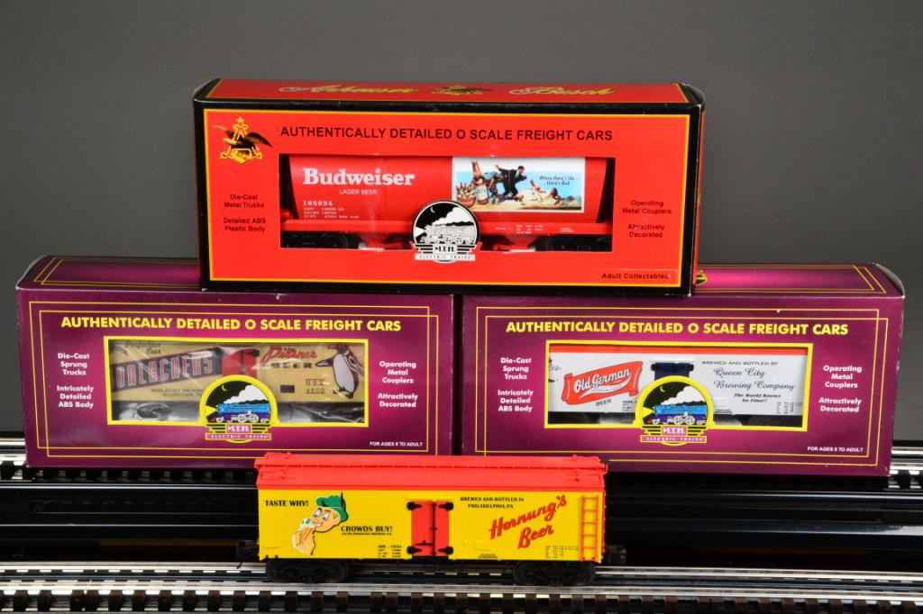 (4) M.T.H. ELECTRIC TRAIN CARS - O SCALE: Including Budweiser tank car (#195924) (item #20-97686) painted red with white and multi-colored lettering and logo, 12" L; Hornung Beer freight car, 36' Woodsided Reefer Car (item # 205636e) painted 