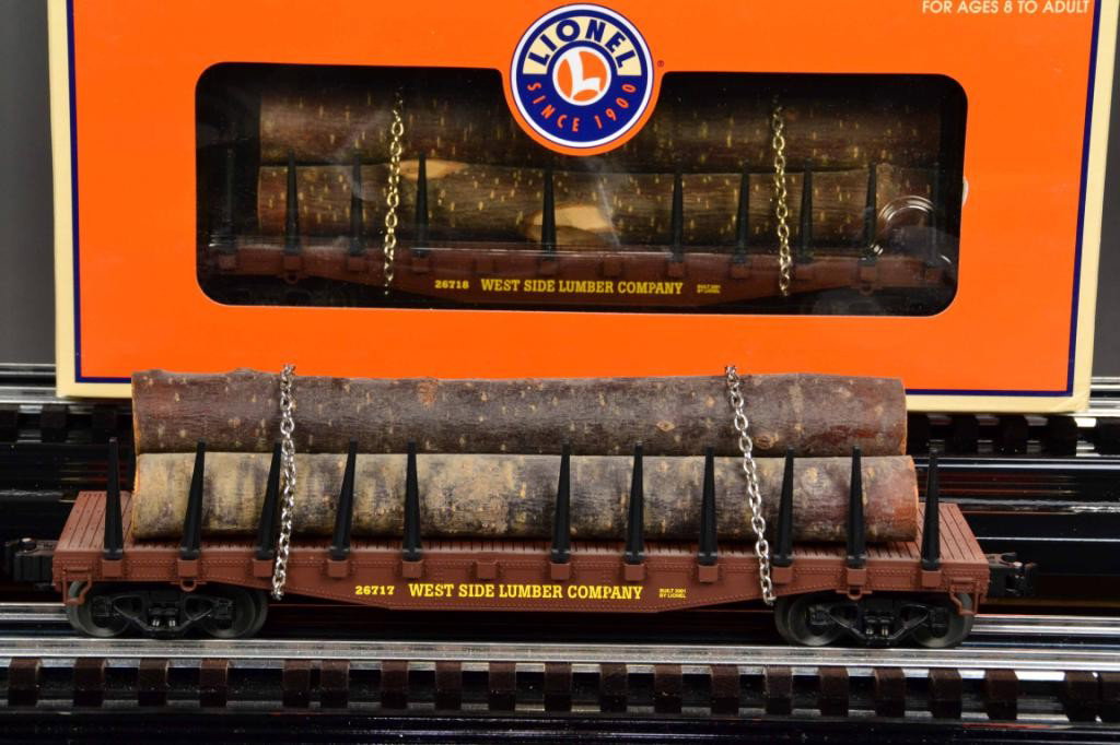 (3) LIONEL WEST SIDE LUMBER LOG CAR: Three identical log carriers loaded with logs held down by chains, painted brown with yellow lettering11" L, new in box. Private collection Metamora MI.