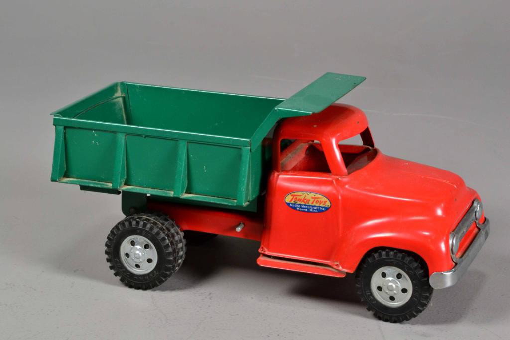 TONKA TOY DUMP TRUCK: Toy dump truck by famous toy manufacturer, Tonka, cab painted red and dumper painted green, punch-pressed construction, circa 1960, very good condition, 13.5" L x 5" W x 8" H. Private collection Metam