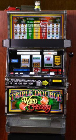 SLOT MACHINE - WILD CHERRY: Square top "Wild Cherry" Casino slot machine with spin reel and handle/arm, 21.25" W x 15.25" D x 43" H,comes with stand, used in good working order. Private collection Metamora MI.