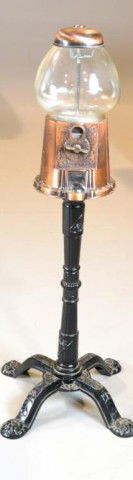 A Carousel Bubble Gum Machine: A brass & copper carousel machine raised on four footed black metal base. 38"H, circa 20th century. Private collection Oxford, MI.