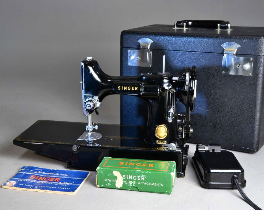 SINGER FEATHERWEIGHT SEWING MACHINE: Singer featheweight including, case, box of sewing attachments, electrical attachment, and 1955 copyrighted instruction manual. 15" L x 9" H x 8.5" D, Case 14" L x 10.5" H x 8" D. Machine in mint cond