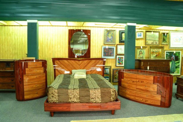 (4) PIECE ART DECO BEDROOM SET: To include a long dresser of kidney shape, a tall dresser with kidney shape, headboard, and matching mirror, the dressers with stepped pyramid drawers, all pieces in two tone contrasting wood, circa 2
