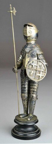 A Fine Silver Suit of Armor: Finely cast after the life size model with removable Halberd, shield, hand shields, moveable face shield and articulated body. The shield cast with two cloverleaf's or flowers and two crosses mounted