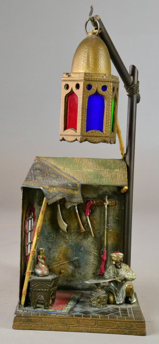 Austrian bronze Arab lamp 19th Century: Cold painted bronze, electrified decorative lamp of scene with Arabian blacksmith hammering a sword, w/ hooka in foreground, lantern lacking one pane of glass, retains it's original antique wireing, s