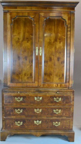 A Fine Aston Court By Henredon Armoire-Wardrobe: A Chippendale style armoire/ wardrobe with molded cornice above two large recessed doors with one interior drawer, lower section has pull out writing surface, above three dovetailed drawers with brass