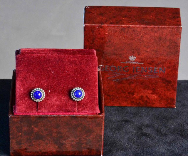 Georg Jensen Sterling And Lapis Earrings: Sterling flower form earstuds with raised beading each containing one round lapis stone. In original box with holder and velvet cloth. Very fine condition. Private collection Troy, Michigan
