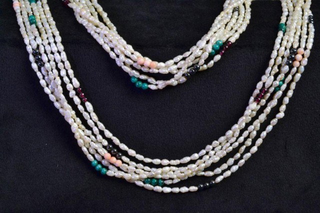 MULTIPLE STRAND FRESHWATER PEARL NECKLACE: Six strands of freshwater rice pearls, each strand interspersed with various round bead grouping: hematite, amethyst, malachite, 17" long. Private collection Clinton Township, MI>