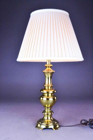 Stiffel Style Table Lamp: A polished brass footed table lamp with brass finial and ivory pleated shade, 29"H to top of finial.In very nice condition and working order. Private collection Troy, MI.