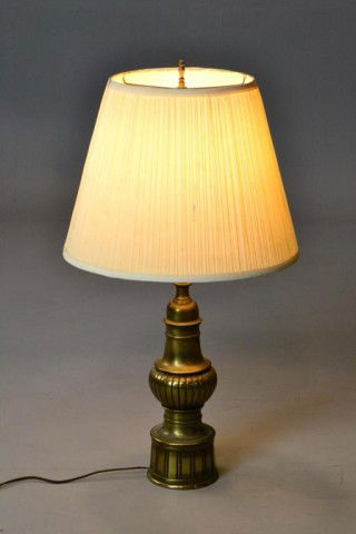 A STIFFEL BRASS TABLE LAMP: Panel design to center and base of lamp, with pleated ivory shade. 31" H to top finial, circa 20th century. Condition: light tarnish wear to brass. Private collection Grosse Pointe, Mi.