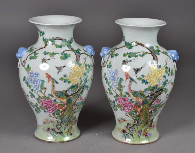 Pr. Chinese Large Famille Rose Enamelled Vases: Pair of matching baluster-shaped white porcelain vases with flared rim, having two blue dragon heads with fixed rings on shoulder, each having polychrome enamelled design on front with stylized peacoc