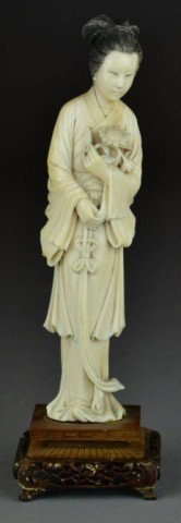 Chinese Carved Ivory Beauty: Finely carved her holding a bouquet of flowers, with fitted carved open work stand, 8.75"H not including stand, circa early 20th century. Private collection of the late Robert A. (Pete) Dorrance.
