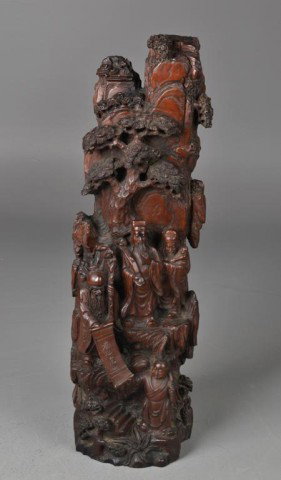 A Fine Chinese Carved Rosewood Mountain: Finely carved to depict elders under an ancient pine one elder holding a scroll with four characters, one holding a ruyi scepter one holding a boy and the other helping to hold the scroll very elabora