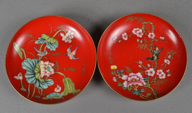Pair Chinese Red Saucers with Decoration: Pair of red glazed porcelain saucers one with lotus and bird decoration, the other with cherry blossom enamelled blue seal on bottom, 5" Diameter. Private collection Rochester Hills, MI.