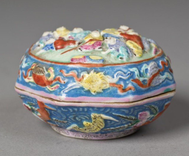 Chinese Qing Famille Rose Porcelain Box: Finely molded to depict boys antiques bats and peaches. The interior and foot rim glazed turquoise the base with molded mark for great Qing Qianlong production 3"w x 2"H circa early 19th century.