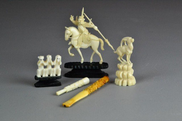 (5) Chinese Carved Ivories: To include two cigarette holders both finely carved to depict dragons, three monkeys, a Chinese warrior on horse with spear, and a carved ram on rocky plinth, largest is 3.5"H, all circa early 20th ce