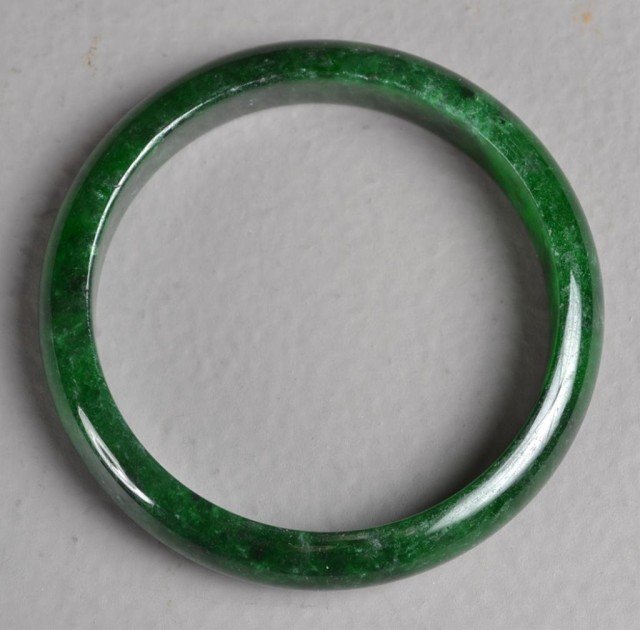 Chinese Carved Spinach Bangle: Finely polished jade bangle of simple design .5" thick, 3" Diameter. Private collection Rochester Hills, MI.