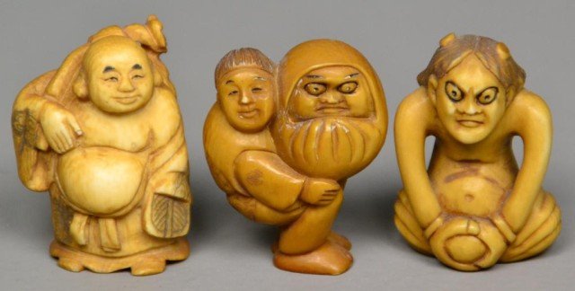 (3)Japanese Carved Ivory Netsuke: Probably Meji period, finely carved, one to depict a man carrying a large baby, one seated man, and one elder with a staff, tea stained with inked and dyed elements, each with a different character ma