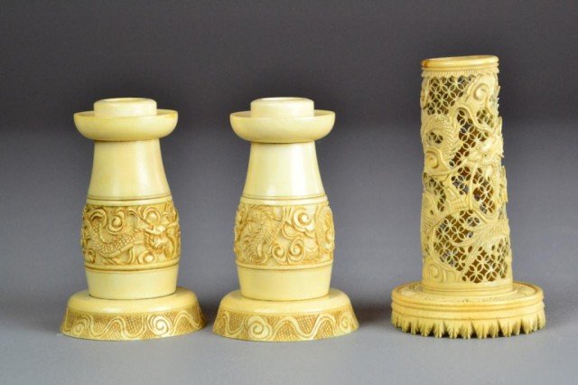 (3) Pcs. Chinese Carved Ivory: To include a finely carved pair of candle stands depicting dragons, together with a finely carved openwork vase, depicting floral and fauna, largest is 4"H, circa late 19th/early 20th century.