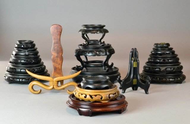 (21) Chinese Carved Wood Stands: To include various solid and pierced wood stands in different sizes and colors. Largest is 9" D. Circa mid 20th century.