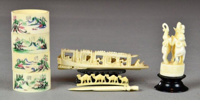 (8) Pieces Asian & Indian Carved Ivories: Carved ivory boat or 'junk', and indian ivory depicting three standing elephants, an ivory herd of camels, an ivory bookmark depicting an elephant and four Japanese ivory napkin rings all with four li