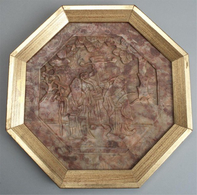 A Fine Chinese Carved Soapstone Plaque: Finely carved to depict figures within a landscape, octagonal in shape, mounted in a carved giltwood frame. 10.5" H x 10.5" W, circa late 19th/early 20th century. The frame possibly newer. Private col