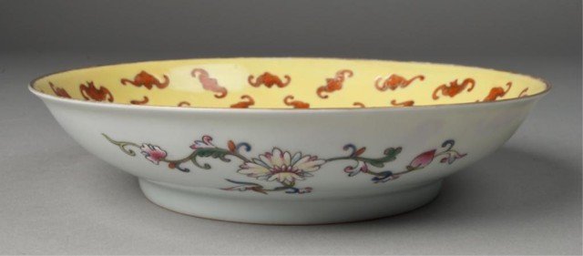 A Fine Chinese Porcelain Footed Low Bowl: Interior in saffron yellow ground with numerous bats in iron red and gilt, outer decorated with floral and scrolling designs. 2" H x 8.5" Dia. Four character mark in iron red on underside. Surface cra