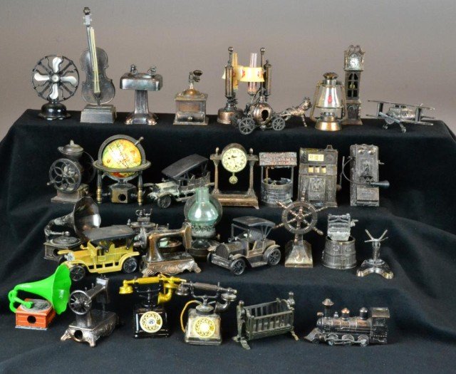 (44) Doll House Miniatures & Pencil Sharpeners: A variety of metal die-cast copper-color miniatures of wagon trains, scales, fans, telephones, etc., many pieces suitable for dollhouse furniture: grandfather clock, sewing machine, sink, world globe,