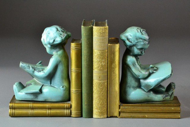 (4) Pr. Of Metal Bookends With Two Early 20th C. B: Bookends depicting painted green cherubs writing with pen in hand, resting their back and legs against gold books, 6" H, including a book titled Millet, and another Sartor Resartus by Thomas Carlyle, 