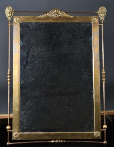 A Very Fine Bronze Mirror in the Neoclassical Tast: With finely cast masks to top corners, centered by a bronze wreath and clam, the four corners with bronze rosettes, with beveled glass, with additional openwork frame in bronze tubing with bold turnin
