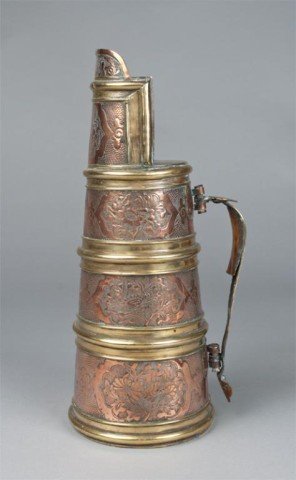 A Fine English Brass and Copper Ale Pitcher: The copper body with brass bands, the body with fine repousse work depicting cartouches of flowers. Unmarked, 13.25" H, circa 18th century. Private collection Farmington Hills, MI.