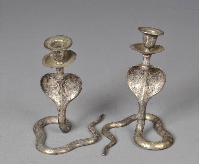 Pr. Of Silver Plated Cobra Candlesticks: Depicting a rising cobra with candle holder and plate attached at head. 7" H x 6" W, circa mid 20th century. Private collection Troy, MI.