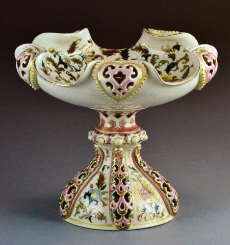 a Fine Zsolnay Porcelain Centerpiece: Finely decorated with raised pierced openwork and profusely painted with floral and scroll decoration in bright enamels, impressed Zsolnay mark Pecs #1744 to base with further painted mark for Zsolnay